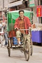 Man on cargo bike in a narrow alley, Xian, China